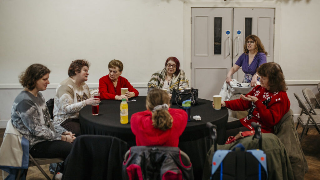 A group of women sit around a table at our weekly craft group in Sheffield.