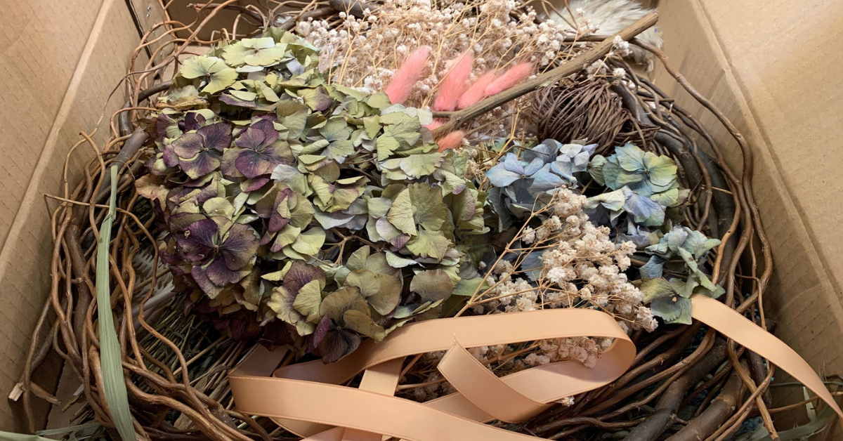 A box of dried foliage for a wreath-making session.