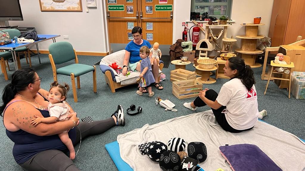 Three women and two babies are taking part in a Barnsley playgroup session.