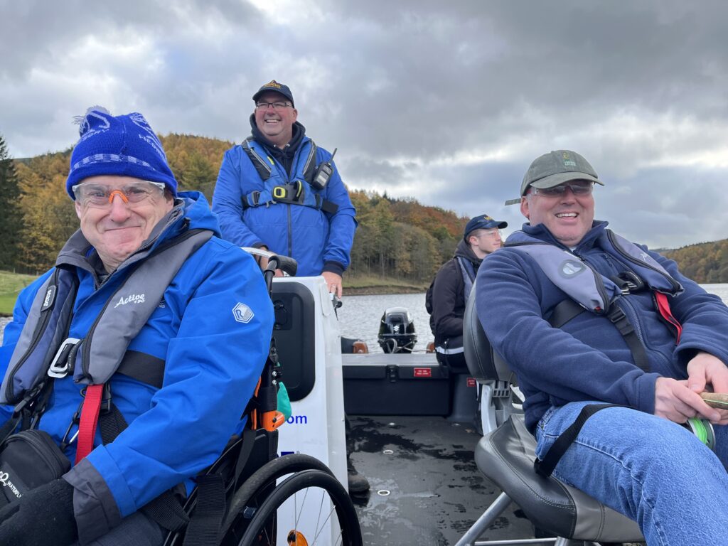 SHASBAH charity trustee Phil on a boat with other members at Ladybower Fisheries.